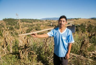 A farmer in front of a field