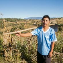 A farmer in front of a field